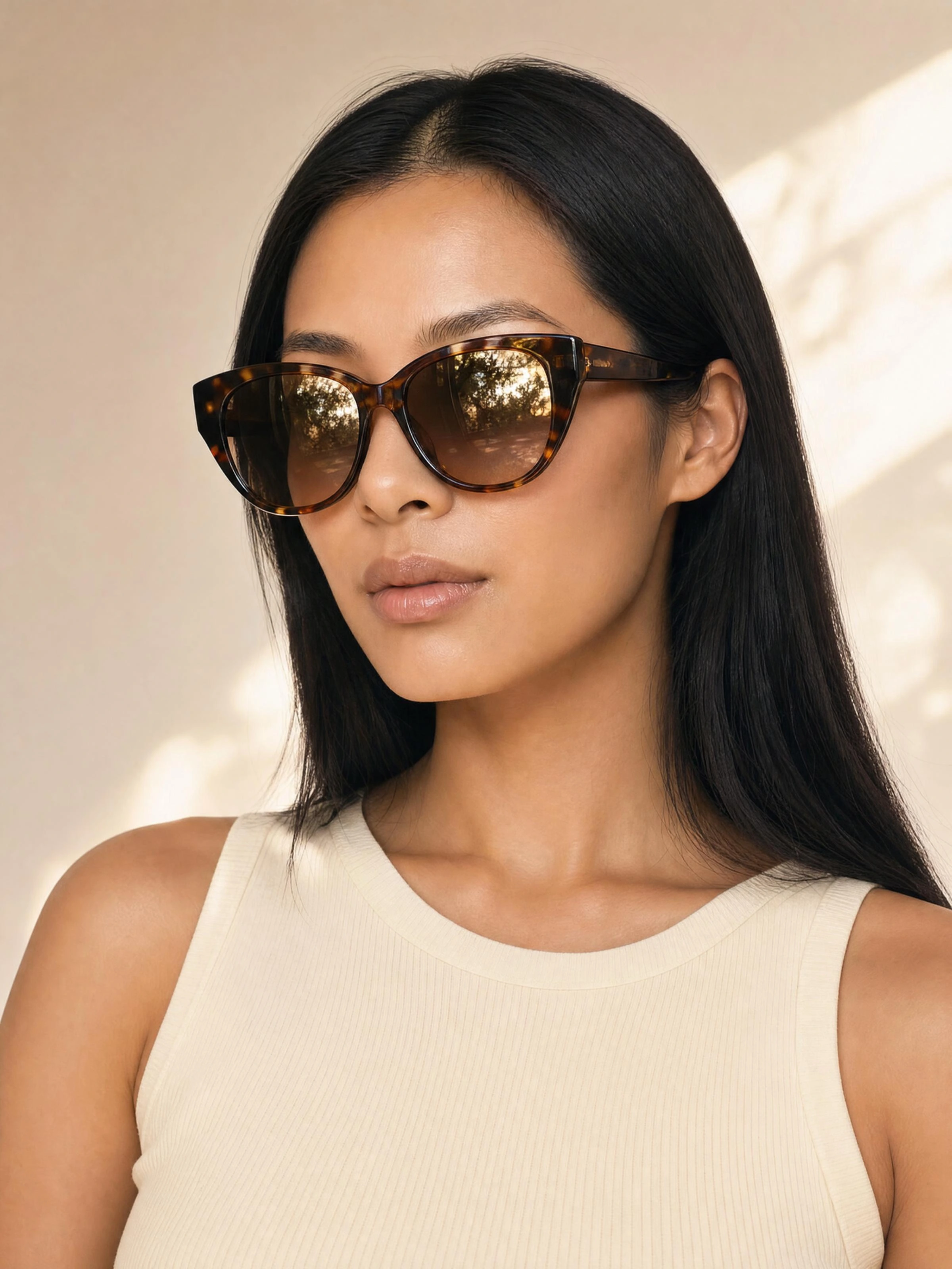 Alexandra wearing tortoiseshell sunglasses in soft sunlight